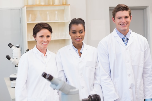 Smiling scientists team looking at camera 