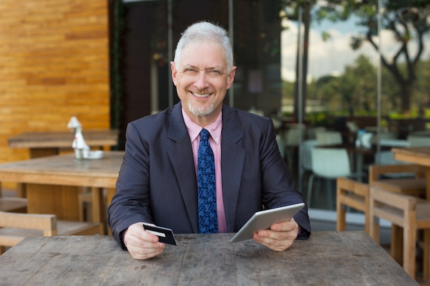 Smiling Senior Business Man with Credit Card