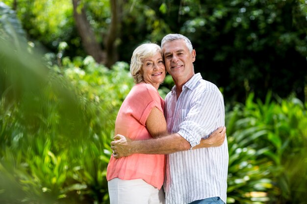 Smiling senior couple embracing at yard