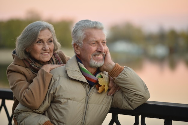 Smiling senior couple posing in park