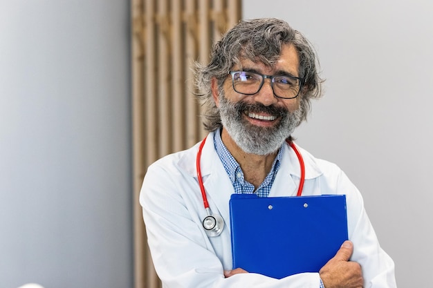 smiling senior doctor looking at camera in hospital
