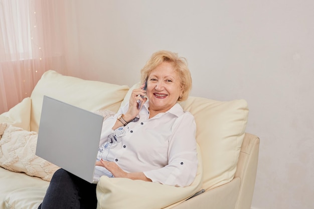 Smiling senior woman having conversation on phone