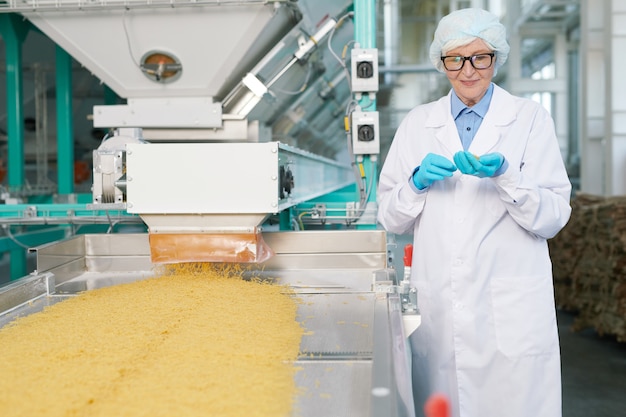 Smiling Senior Woman at Production Line