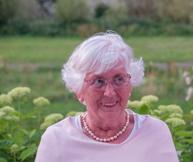 Smiling senior woman sitting outdoors