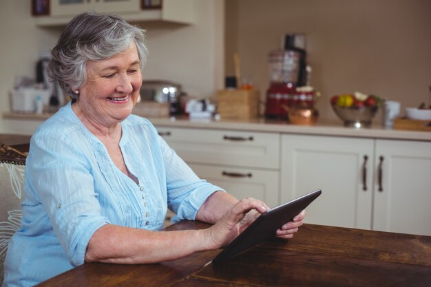 Smiling senior woman using tablet 