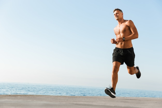 Smiling shirtless sportsman