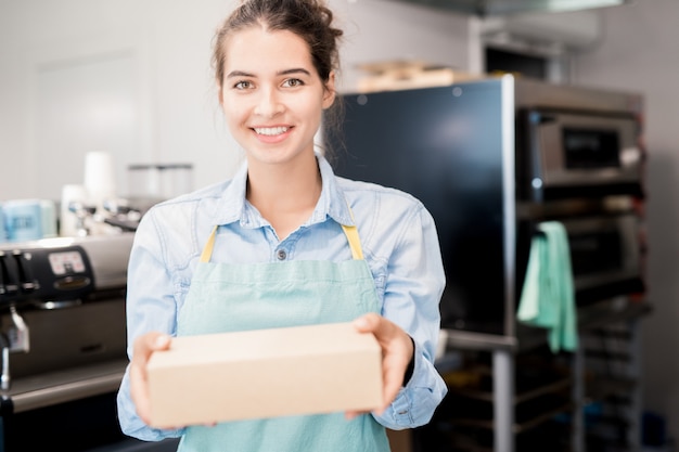 Smiling Shopkeeper Holding Box