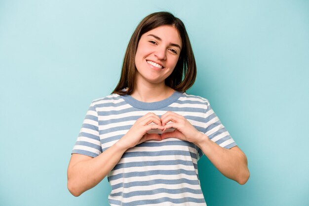 Smiling and showing a heart shape with hands