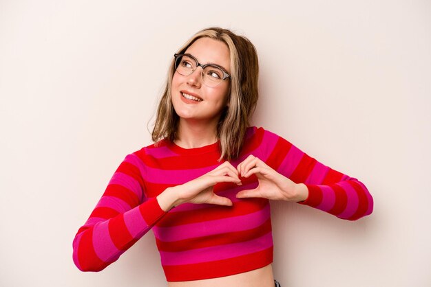 Smiling and showing a heart shape with hands