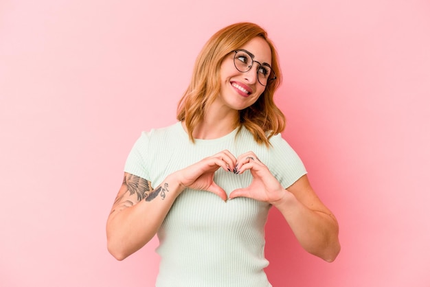 Smiling and showing a heart shape with hands