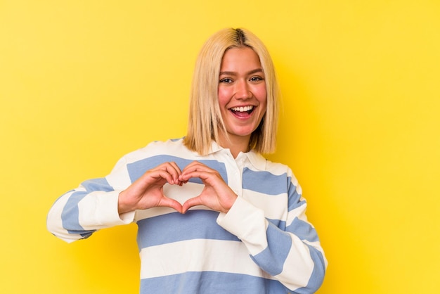 Smiling and showing a heart shape with hands