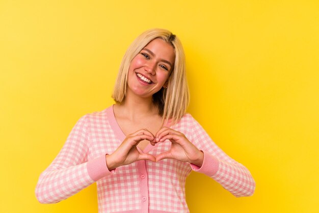 Smiling and showing a heart shape with hands