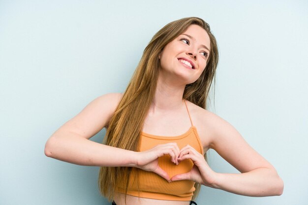 Smiling and showing a heart shape with hands