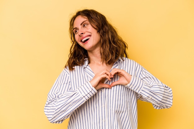 Smiling and showing a heart shape with hands