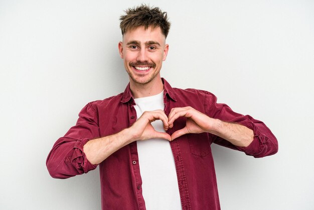 Smiling and showing a heart shape with hands