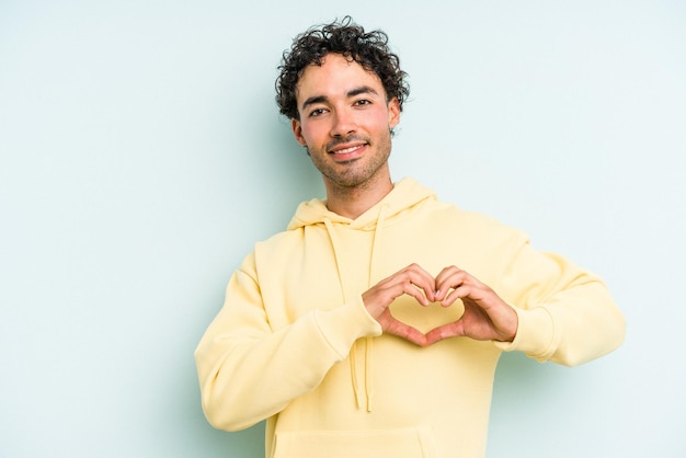 Smiling and showing a heart shape with hands