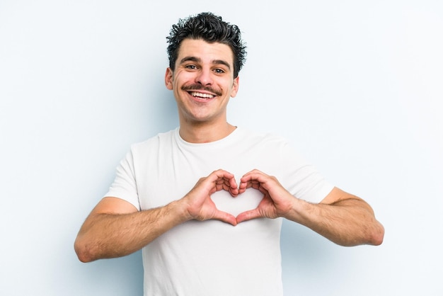 Smiling and showing a heart shape with hands