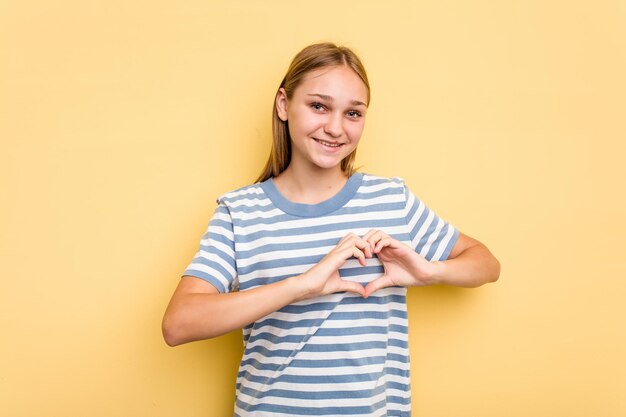 Smiling and showing a heart shape with hands