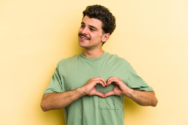 Smiling and showing a heart shape with hands