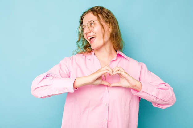 Smiling and showing a heart shape with hands