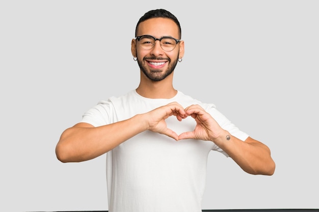 Smiling and showing a heart shape with hands