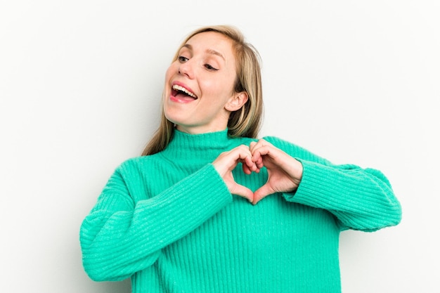 Smiling and showing a heart shape with hands