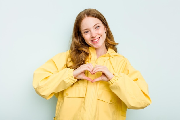 Smiling and showing a heart shape with hands