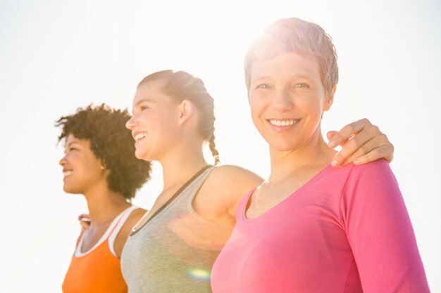 Smiling sporty woman with two friends