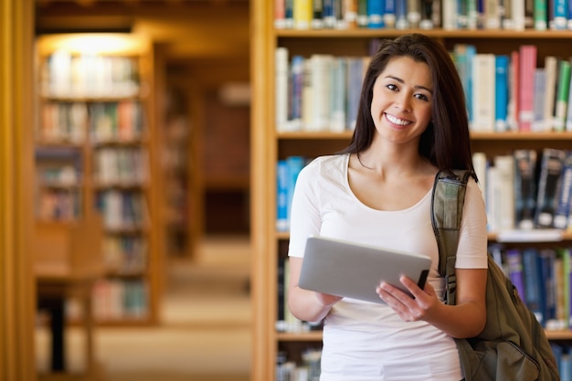 Smiling student using a tablet computer