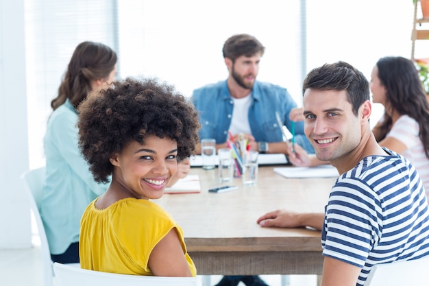 Smiling students at the table