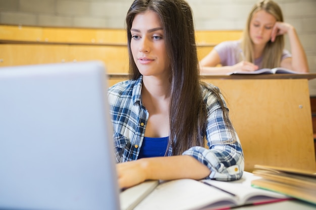 Smiling students working in class in university