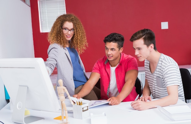 Smiling students working together on computer