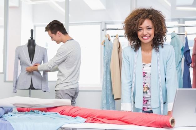 Smiling students working with fabric and model