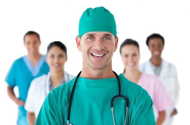 Smiling surgeon in front of his team