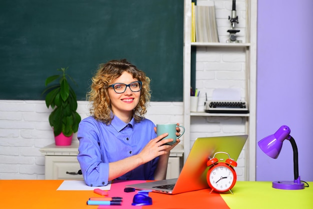 Smiling teacher in classroom funny female teacher in classroom student in college world teachers day