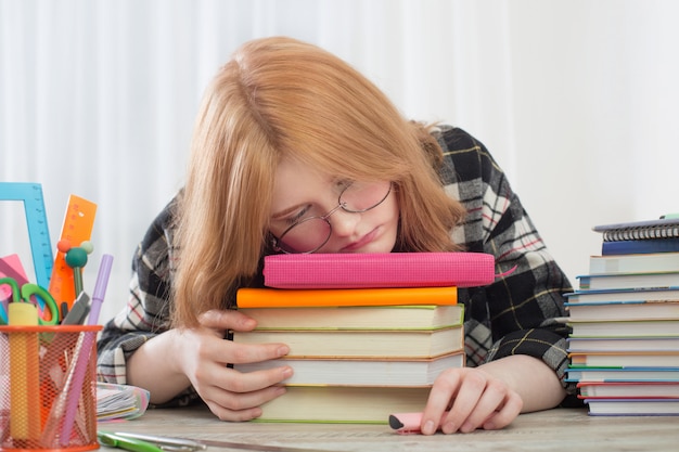 Smiling teenager student girl doing homework at home, education and school concept