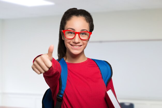 Smiling teenager student holding a book