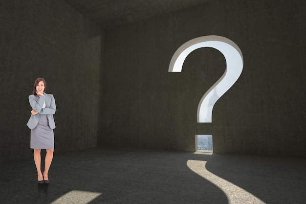 smiling thoughtful businesswoman against question mark door in dark room