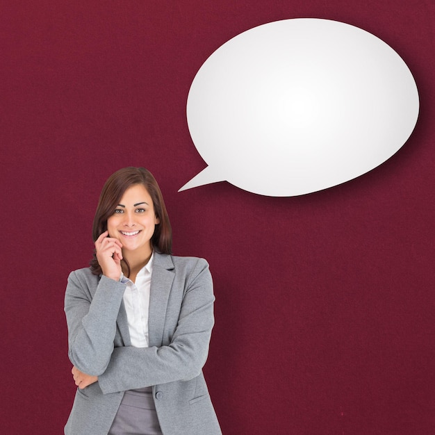 Photo smiling thoughtful businesswoman against speech bubble