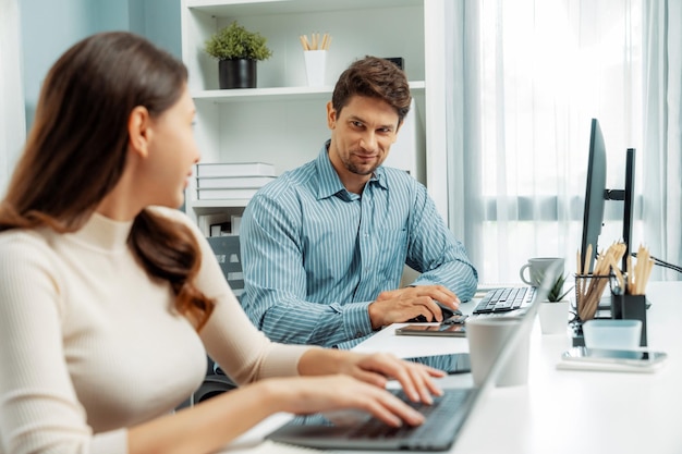 Smiling two colleagues talking together of business analysis Postulate