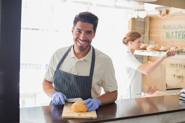 Smiling waiter at the coffee shop counter