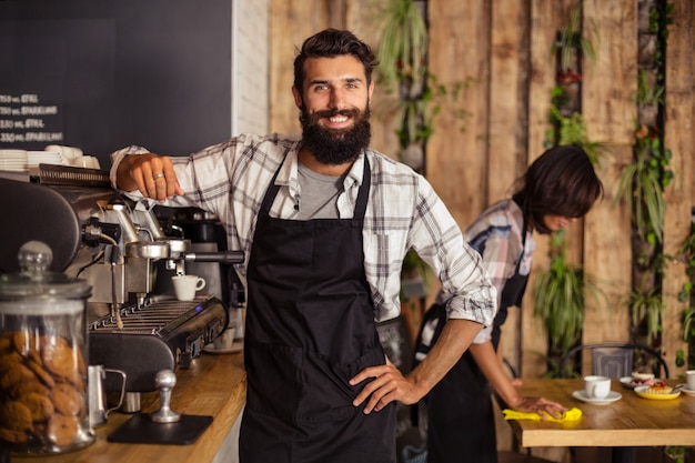 Smiling waiter standing in kitchen at cafÃ©