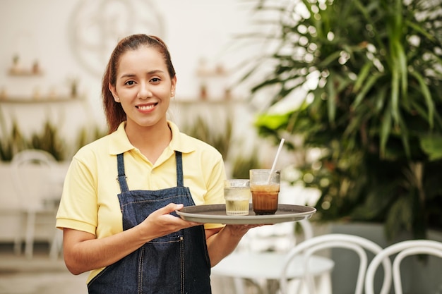 Smiling Waitress Holding Tray with Drinks