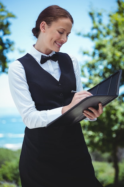 Smiling waitress taking an order