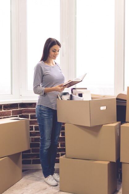 Smiling while packing her stuff into the boxes ready to move