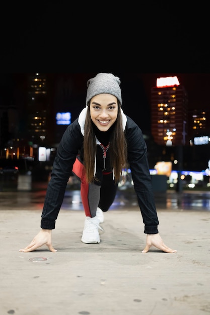 The smiling while prepares for a night run around the city