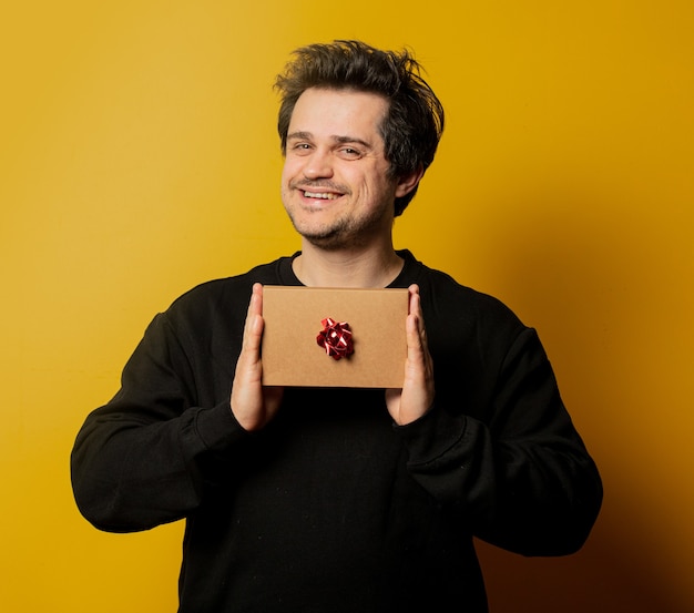 Smiling white guy with gift box