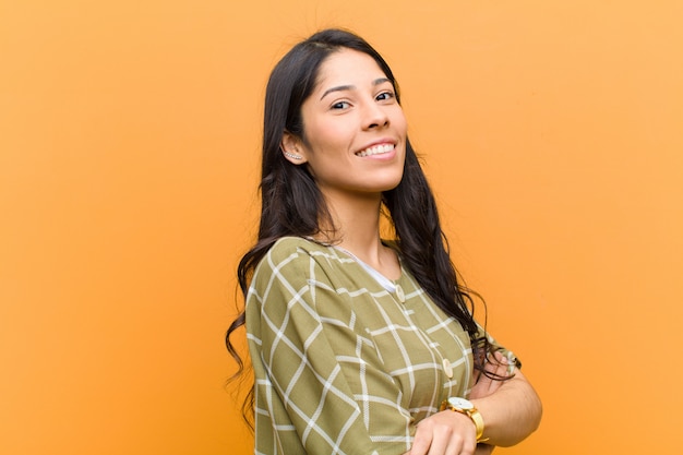 smiling with crossed arms and a happy, confident, satisfied expression, lateral view