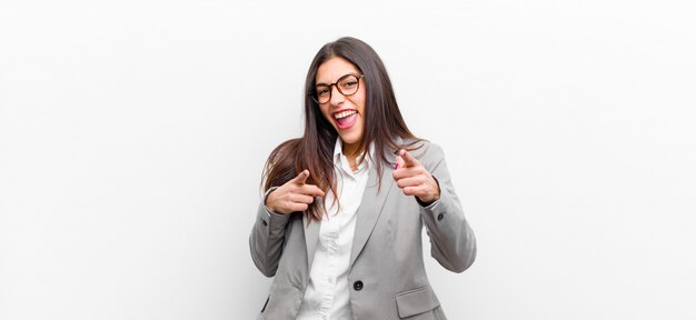 smiling with a positive, successful, happy attitude pointing to the camera, making gun sign with hands