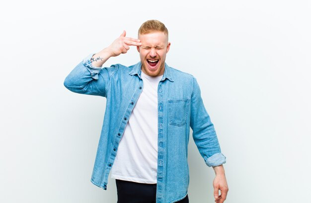 smiling with a positive, successful, happy attitude pointing, making gun sign with hands